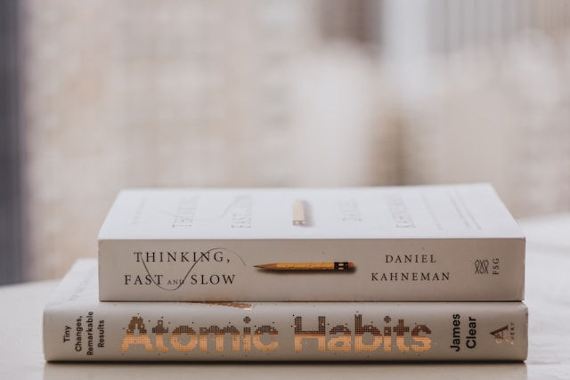 Photo Courtesy of Lala Azizli, photo of two books, "Thinking, Fast and Slow" and Atomic Habits