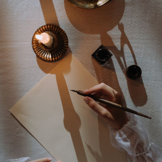 Woman writing with a calligraphy pen