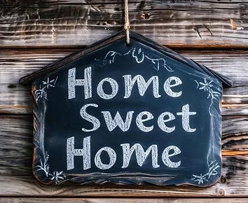 ai-generated-home-sweet-home-written-on-a-chalkboard-on-a-rustic-wooden-background-photo.j