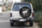 Thumbnail: Rear view of a white Ford Bronco with a SpareCover tire cover installed.