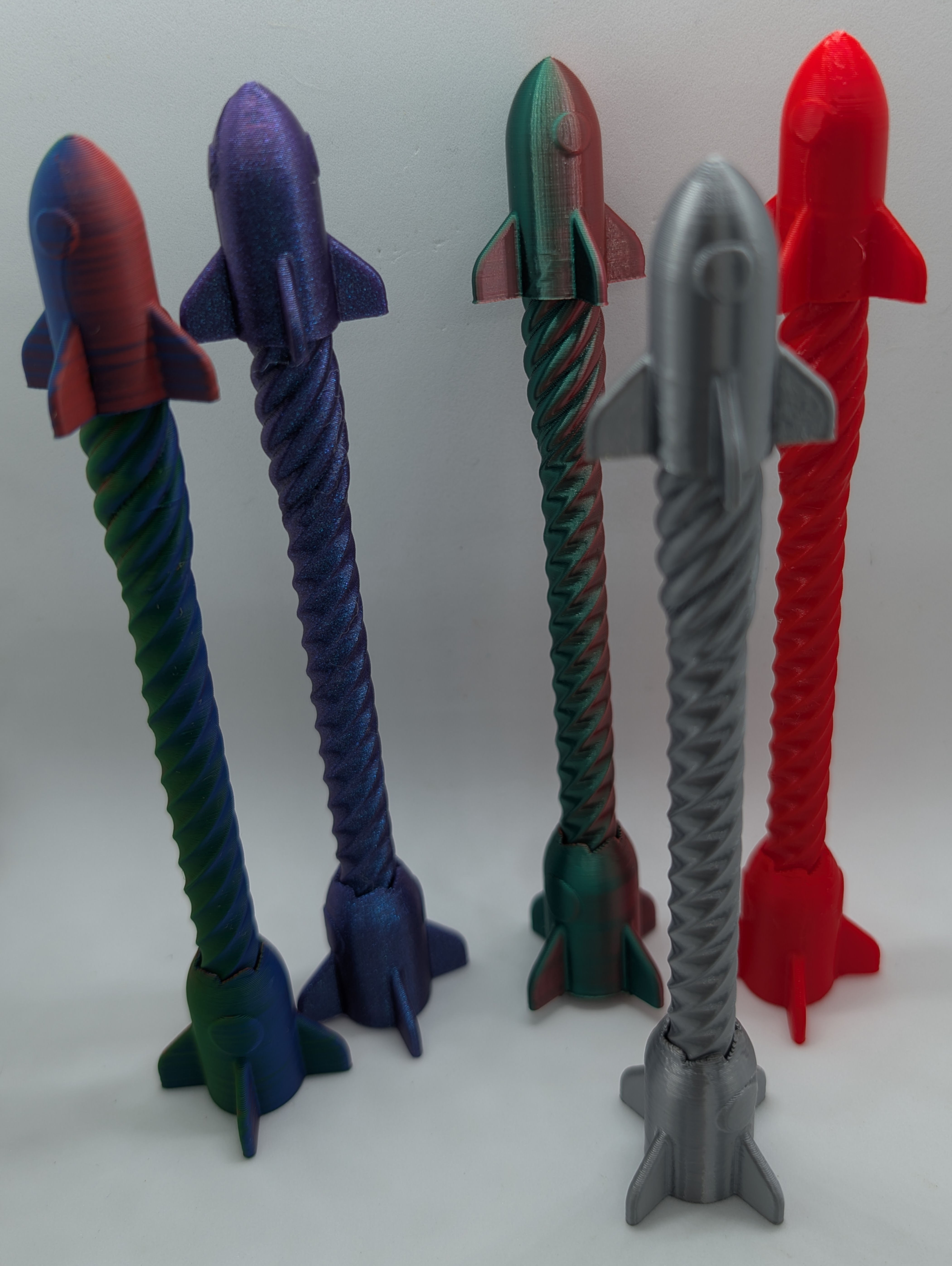 Rocket fidget pens shown in multiple colors.