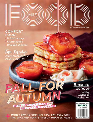 side shot of pancake stack with poached plums and syrup drizzle 