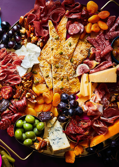 Waitrose weekend feature - charcuterie board packed with cheese, crackers, salami and olives 