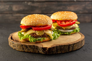 front-view-chicken-burgers-with-cheese-and-green-salad-on-the-wooden-desk-and-sandwich-fas