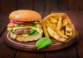 big-sandwich-hamburger-with-juicy-beef-burger-cheese-tomato-and-red-onion-on-wooden-table.