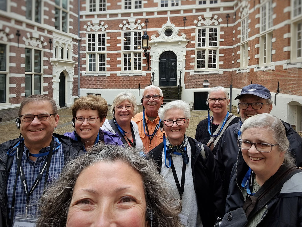 A selfie taken by Inbal Tur-Shalom while guiding a group of tourists in Amsterdam, with the Bushuis – Oost-Indisch Huis in the background.