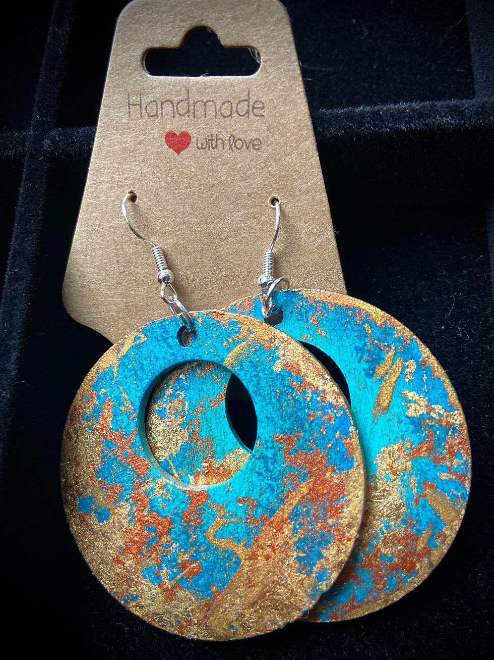 Thumbnail: Round shaped limited edition turquoise, copper and gold handmade earrings, inspired by Jo Cooney's painting, “In This Moment,” displayed beautifully on black velvet.