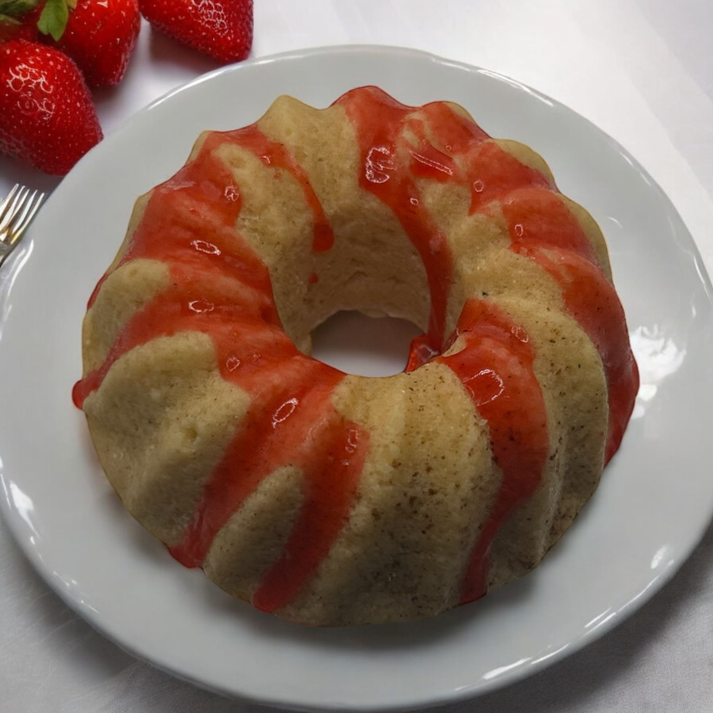Strawberry-glazed bundt cake on a plate