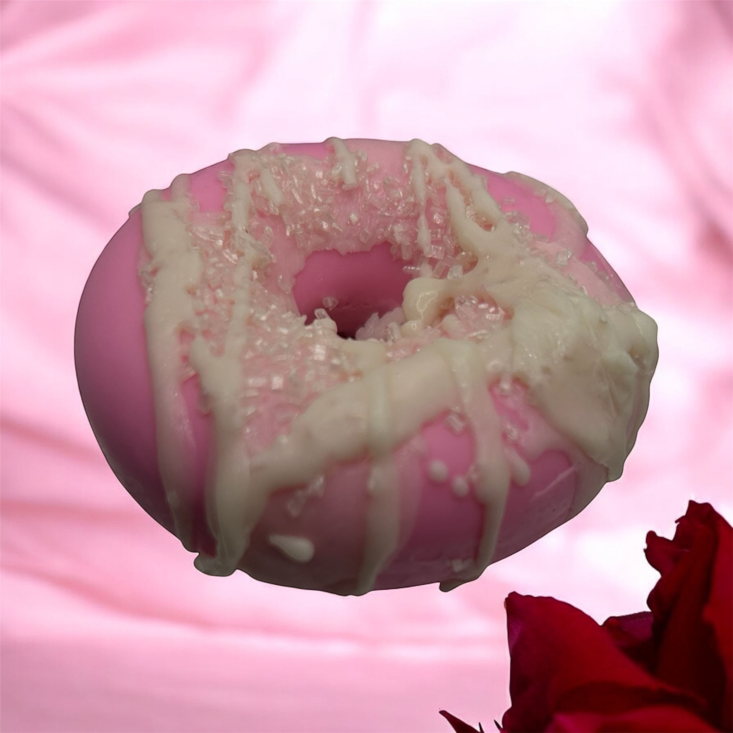 Pink donut with white icing and sprinkles