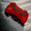 Thumbnail: Red wireless game controller on wet surface