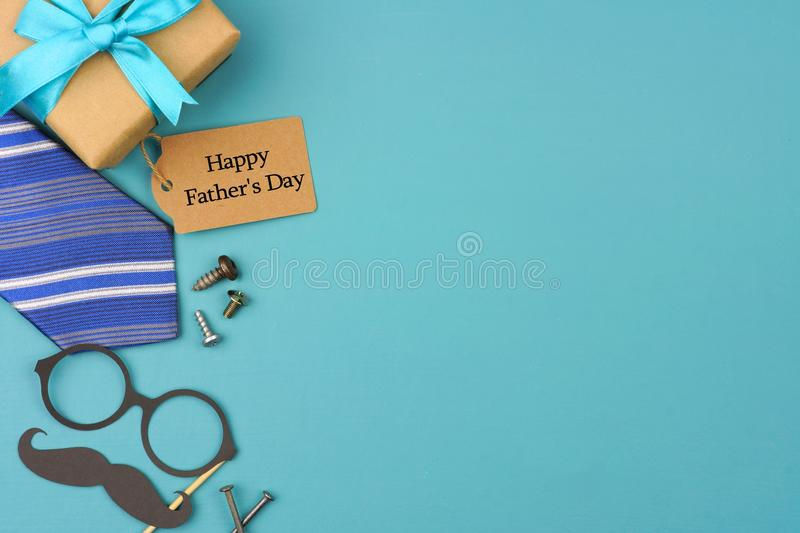 happy-fathers-day-gift-tag-side-border-blue-background-gifts-tie-decor-top-view-copy-space