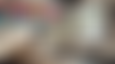 An office desk with a fan on the blowing money out of an open window – an analogy for old-fashioned thinking that a customized CRM system is like wasting money