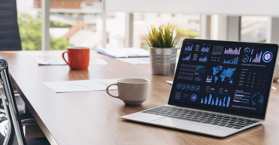 Laptop displaying Business Central analytics dashboard with charts, KPIs, and global data insights on a modern office desk with coffee cups and a plant in the background.
