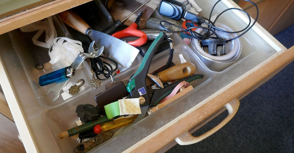Cluttered drawer of tools and wires, illustrating disorganized systems during ERP data migration process