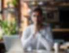 Thoughtful doubtful businessman in tension thinking make difficult decision at work, stressed man put hands in prayer pray with hope pondering reflecting concerned about problem challenge sit at desk