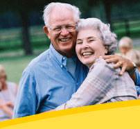 Elderly couple embracing and laughing