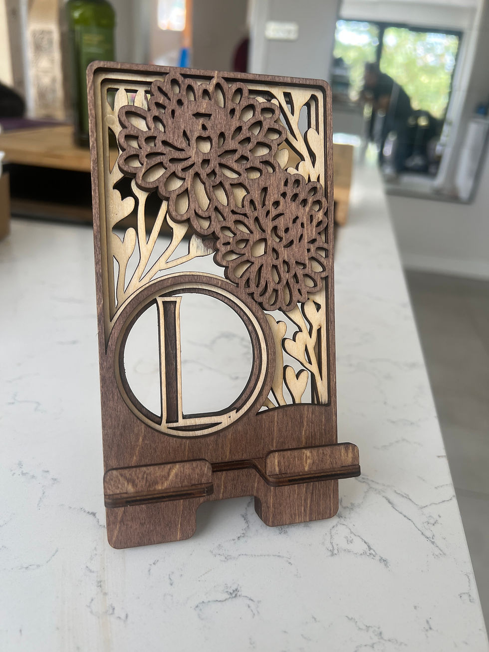 Thumbnail: Wooden phone stand with floral design and the letter L 3dLaserStudio