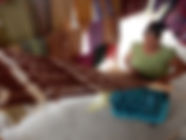A Mayan textile maker weaving a rug in Guatemala