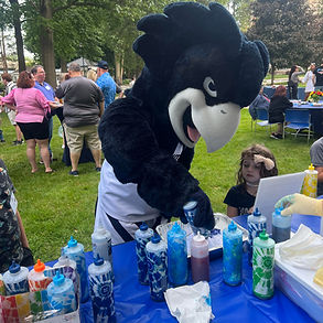 The monmouth university mascot smiling and having fun while enjoying the tie dye event at the university