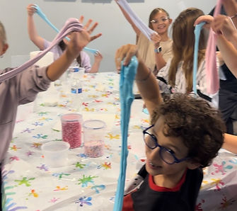 Children stretching and playing with slime at a slime party in NJ