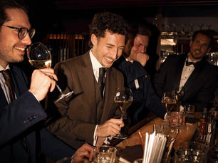 Gentleman enjoying a glass of wine in a relaxed setting, reflecting the culture of slow wine drinking, mindful appreciation, and refined living.