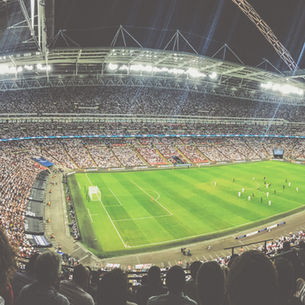 Floodlit football stadium packed with fans, illustrating the AC Milan vs Benfica Europa League correct score and BTTS prediction