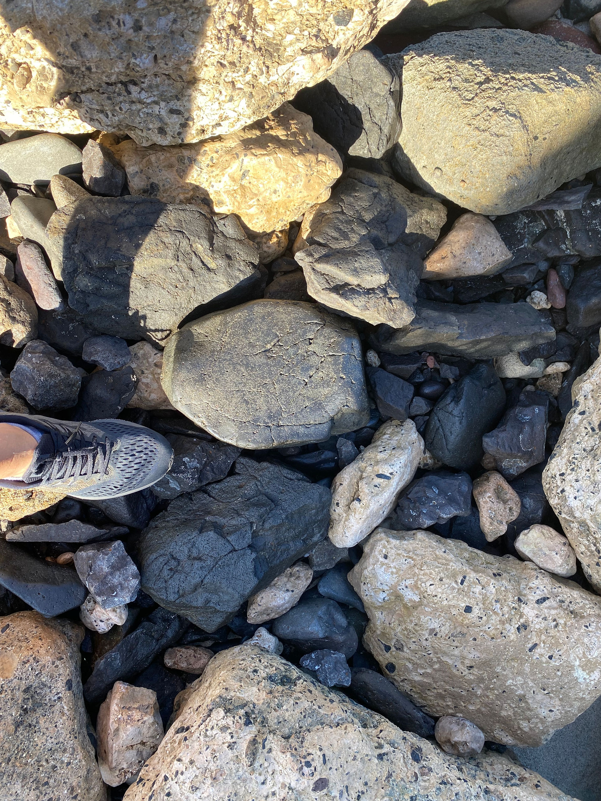 Stone size comparison with a foot