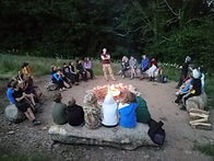 Gathered around the campfire at night in the Bioasis