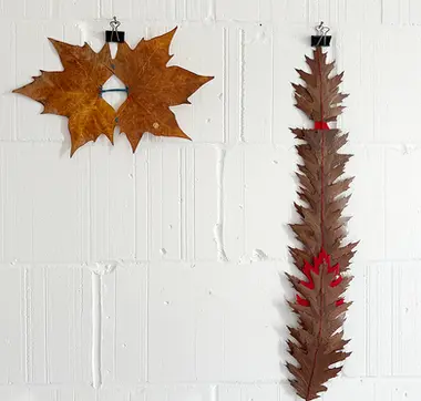 Two unframed works made of embroidered leaves  