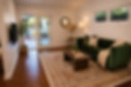 Family room with Smart TV, dedicated workspace, comfortable seating, and patio access in a furnished West Hills home.