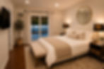 Primary bedroom with king bed, Smart TV, and private patio access in a furnished West Hills home.