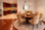 Dining area with seating for six next to the fully equipped kitchen in a furnished West Hills home.
