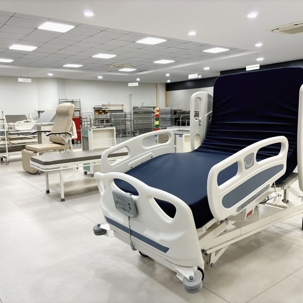 Electric ICU hospital bed with side rails and adjustable features in showroom at Aslam Enterprises
