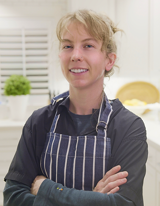 Chef Malea Dickerson of Moonflower kitchen with arms crossed and smiling at the camera