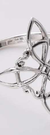 Witches Knot sterling silver ring on white background