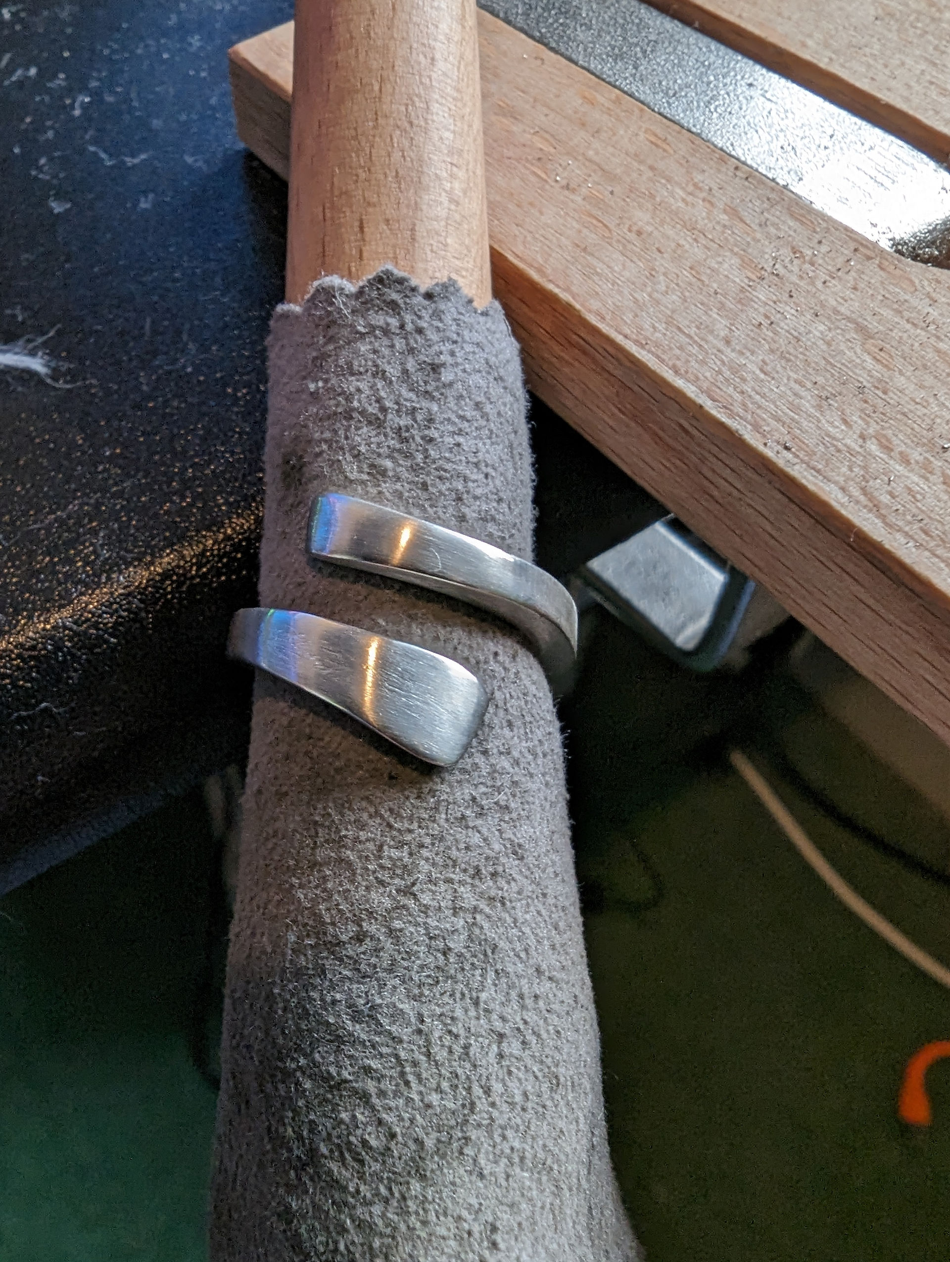 open silver ring on silver polish cloth