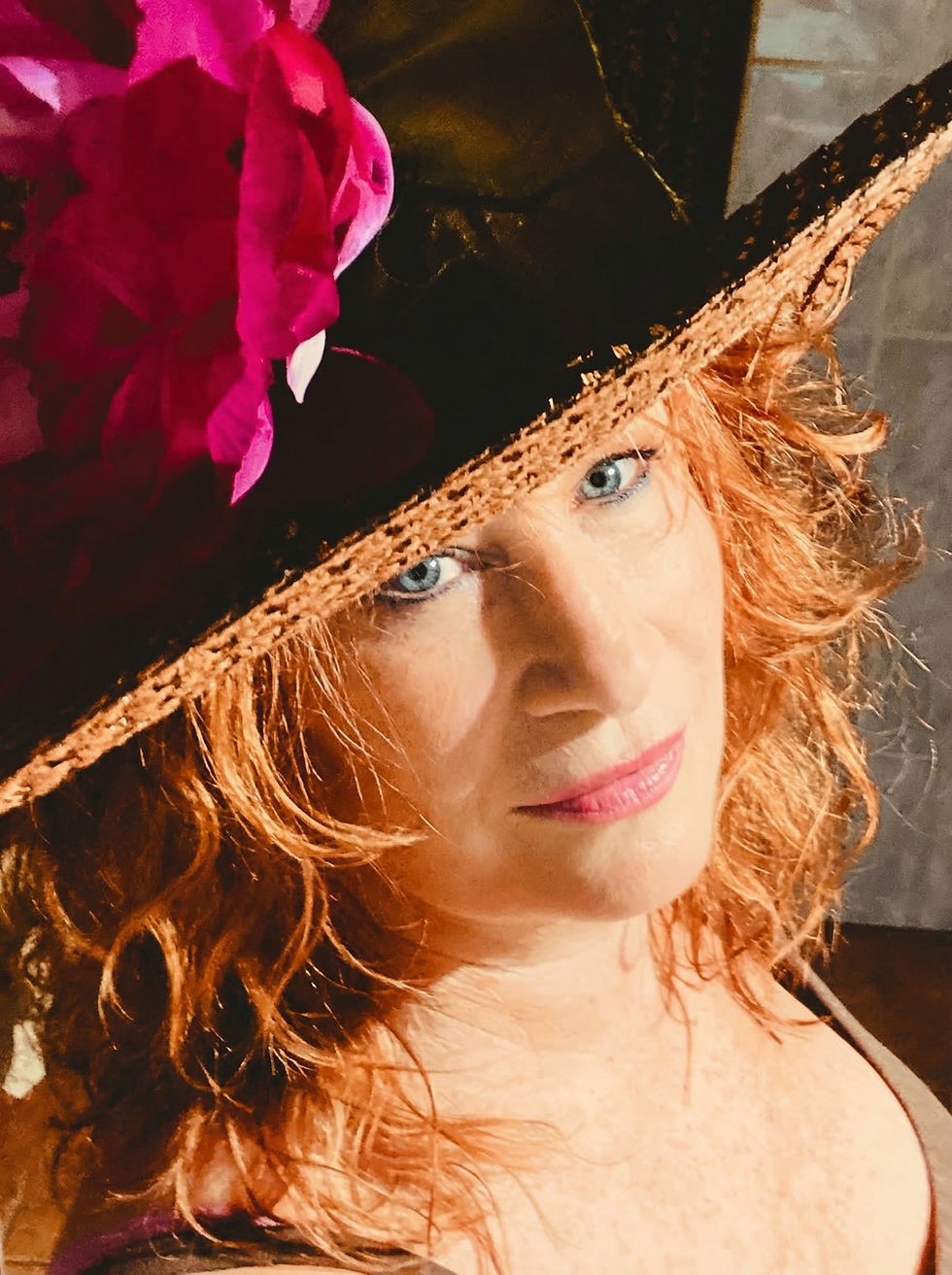 Kim Hurley author headshot with stylish hat and confident expression