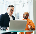 man-using-silver-laptop-beside-another-m