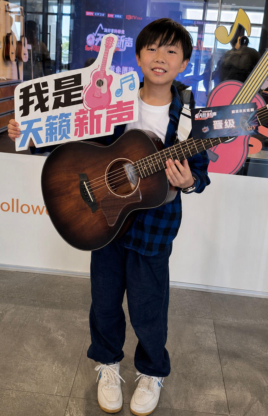 Elijah proudly shows his entry pass after qualifying for the next stage of the competition.