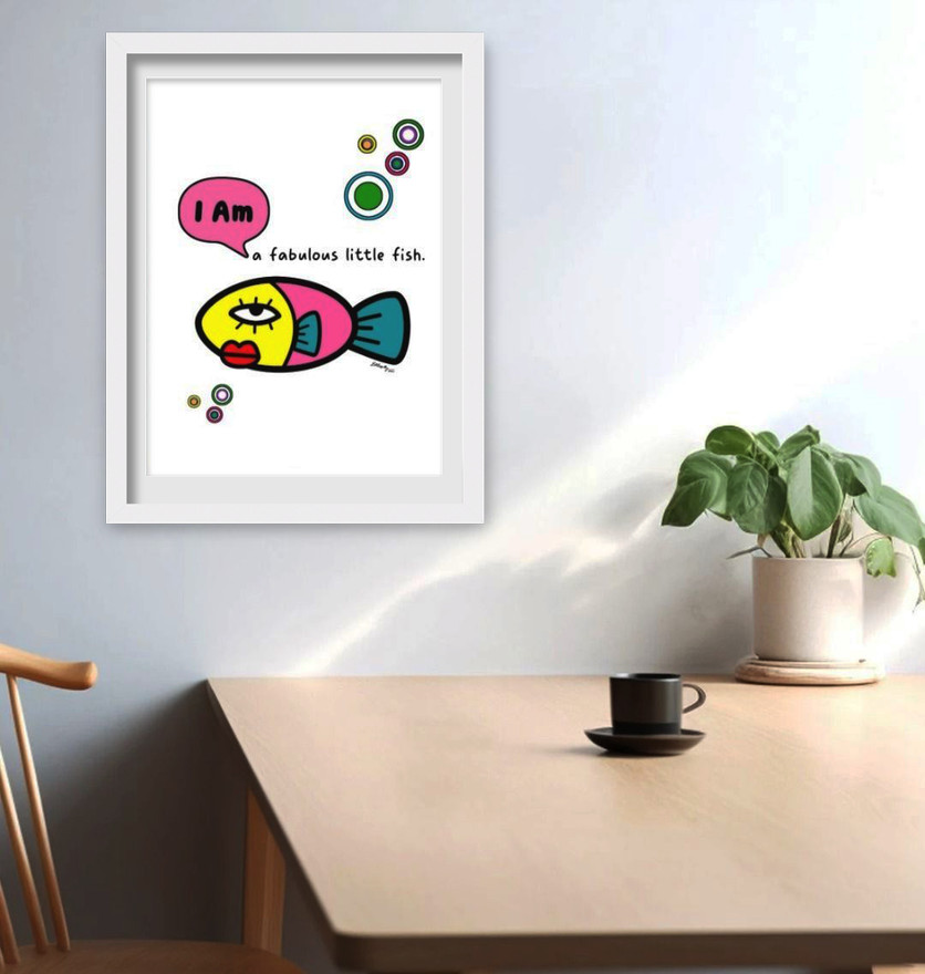 Framed whimsical fish wall art hanging above a modern desk space.