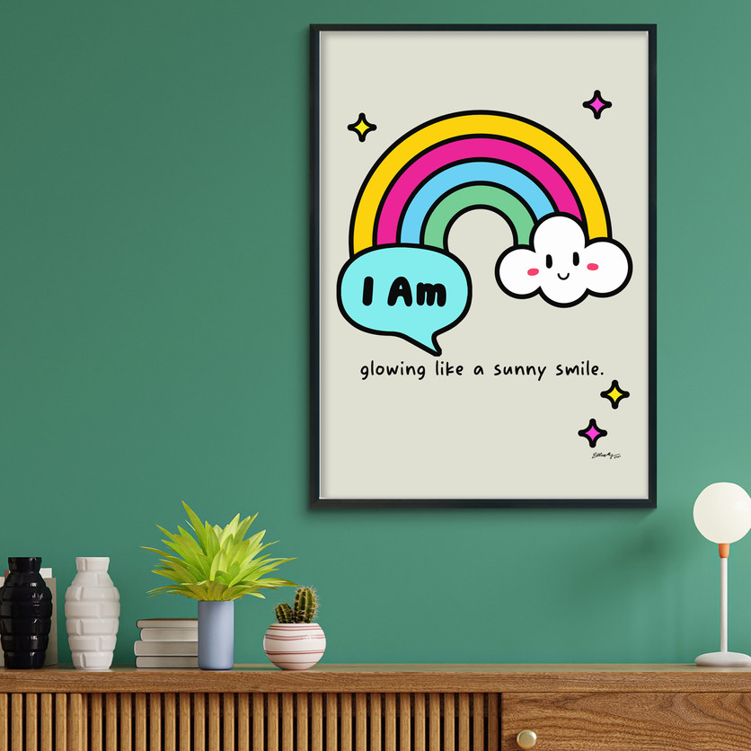Framed rainbow affirmation wall art displayed on a green wall above a shelf.