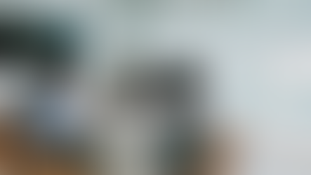 5 people sitting around business conference table talking