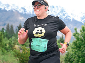 Emily running a marathon wearing a Te Tahi Youth shirt to raise funds for young people’s mental health support.
