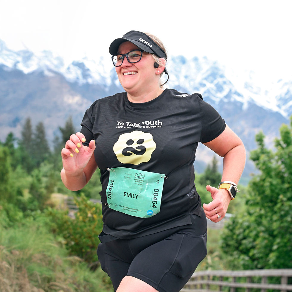 Emily running a marathon wearing a Te Tahi Youth shirt to raise funds for young people’s mental health support.