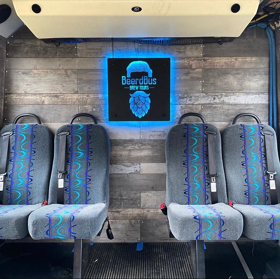 Wood walls and backlit sign inside the bus