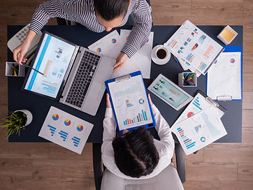 top-viewtop-view-manager-employee-doing-teamwork-business-office-looking-charts-laptop-dis