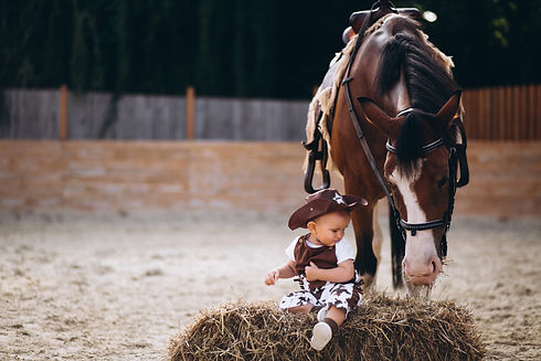 little-cowboy-sitting-on-hay.jpg