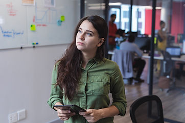caucasian-female-creative-worker-using-tablet-computer-looking-away-modern-office-creative