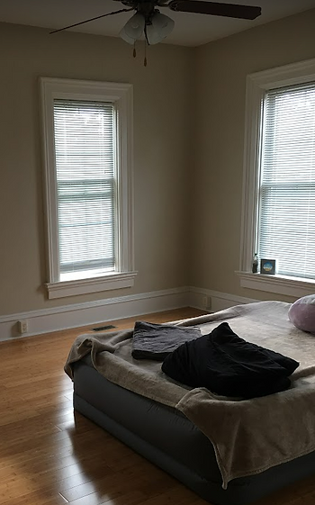 Pictured is an inflated bed, some sheets, and all windows open to let out the stale, hot smell of the bedroom. I can smell and feel it now.