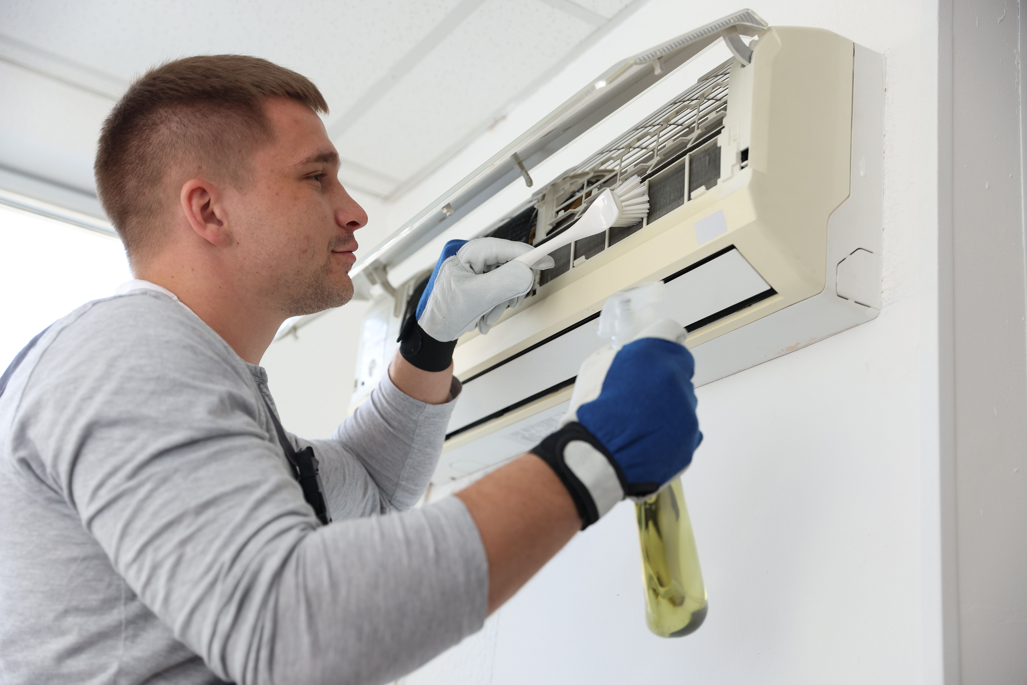 male-technician-cleaning-an-air-conditioning-unit-sml.jpg